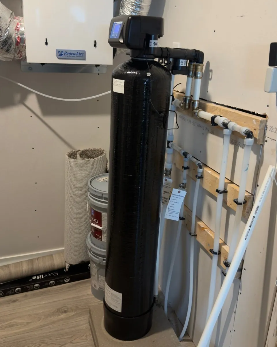 Whole-home filtration tank installed by MSP Pure Water on a level pad beside the plumbing manifold